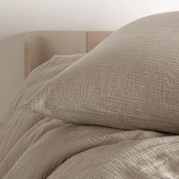Beige cotton muslin pillowcase, textured weave, soft neutral bedding, square 65x65 size.