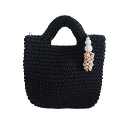 A black crocheted handbag with a zipper closure and a decorative charm or bead attached.