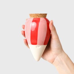 A pink and red striped plant pot made of white clay.