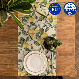 Linen-cotton table runner with a printed lemon leaf pattern, available in two sizes.