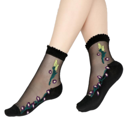 Black sheer socks with polka dot pattern and pointed toe high heels.