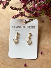 Gold-tone stainless steel earrings with real Gypsophila flowers, featuring a diamond-shaped design.