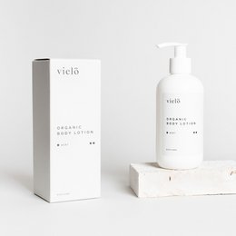 Organic body lotion in a 250ml bottle, with a minimalist white and gray design. The product is labeled "Explore" and is part of the Vield brand.