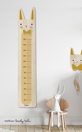 Wooden growth chart with rabbit design, suitable for children's room decor. Measures height with whimsical rabbit motif.