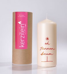 Cream pillar candle with gold text "Oh Tannenbaum" and small star design, 100-hour burn time.