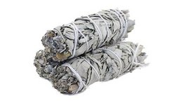 White sage smudge stick, used for cleansing and purification rituals. Cylindrical shape, natural white and gray tones.
