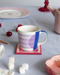  Handpainted chai mug with purple stripes, blue accent, ceramic, modern minimalist design, perfect for tea lovers.