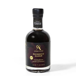 Organic balsamic glaze in a glass bottle. The product is a dark, thick balsamic vinegar glaze made from high-quality ingredients.