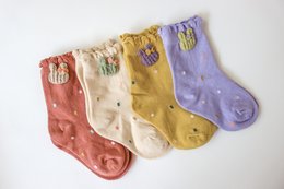Soft, cozy kids' socks in a variety of pastel colors featuring adorable bunny designs. Made from comfortable, breathable materials.