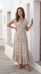 Elegant purple dress with intricate floral pattern and ruffled hem. Flowing, feminine silhouette in a soft, lightweight fabric.