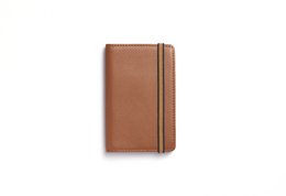 Tan leather card holder with multiple card slots and a minimalist design.