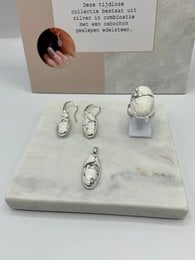 Silver-toned statement rings featuring howlite stones in various shapes and sizes. Includes a pendant necklace with a howlite stone.