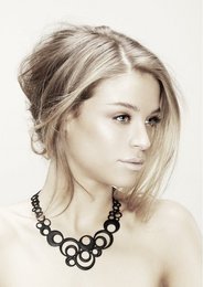 A delicate, silver-toned necklace with a cluster of bubble-like charms. The necklace features a simple, elegant design that would complement a variety of outfits.