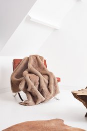 Camel-colored faux-fur throw with wool-cashmere melange lining, featuring a quilted diamond pattern design.