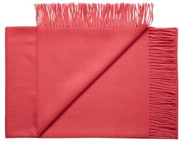 Soft, cozy throw blanket made from premium baby alpaca wool in a solid red color. Features long fringe trim for a stylish look. Ideal for adding warmth and comfort to any living space.