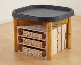 A round wooden tray with a gray lid, featuring three wicker baskets underneath. The tray is designed for use as a play area or activity surface for toddlers.