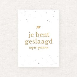 Gold foil text card with the Dutch phrase "Je bent geslaagd" meaning "You have succeeded" or "You have graduated".