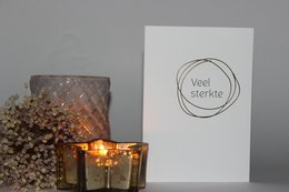 A greeting card with the text "Heaven Good luck" on a white background, accompanied by a decorative candle.
The greeting card features the text "Heaven Good luck" in a simple, elegant font. The card is presented against a plain white background, allowing the text to be the focal point. A decorative candle with a flickering flame is placed next to the card, adding a warm and comforting ambiance to the scene.