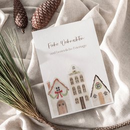 Christmas card featuring illustrated gingerbread houses, festive holiday greeting card with envelope option.