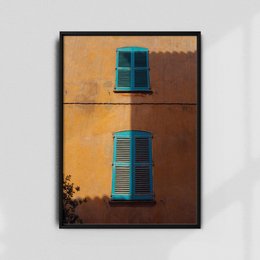 Vibrant orange wall with turquoise shuttered windows, creating a rustic, Mediterranean-inspired aesthetic.