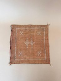 Terracotta silk cushion with cactus pattern, geometric design, boho style, fringed edges.