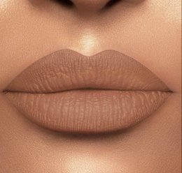 Nutty matte lip gloss in a peach shade with a sleek, modern packaging design.