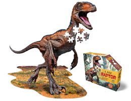A 100-piece puzzle depicting a fierce-looking raptor dinosaur standing on a rocky, grassy terrain. The puzzle comes in a box with the title "I Am Raptor".