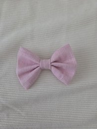 Light pink bow hair clip for kids, made of soft fabric material.