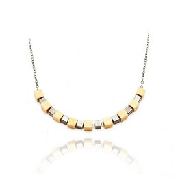 Natural necklace with gold-toned beads and a minimalist design.