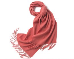 Lambswool scarf in a vibrant coral color, featuring a woven plain design with fringe detailing along the edges.