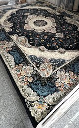 Large dark blue area rug with intricate floral and geometric patterns, suitable for living rooms or bedrooms.