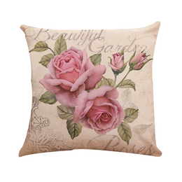 Decorative throw pillow with pink roses and floral pattern, suitable for living room, bedroom, or patio decor.