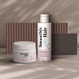 A kids' hair smoothie mask shampoo kit with a smoothie-inspired design, featuring a white bottle and jar with pink and green accents. The product is designed for children's hair care.