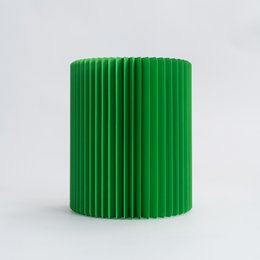 A round, tall green stool made of concertina paper.