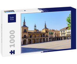 A 1000-piece puzzle depicting the historic town square of Burgo de Osma, Soria, Spain. The image shows the colorful buildings and church towers surrounding the central plaza.