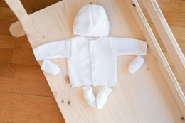 Soft, organic cotton baby suit with hooded jacket and booties in a neutral white color.