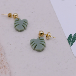 Monstera leaf stud earrings in gold-tone stainless steel or sterling silver. Lightweight, modern, and botanical-inspired design.
