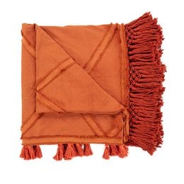 A large, cozy terracotta-colored throw blanket with tasseled edges, suitable for use as a bed cover or decorative accent.