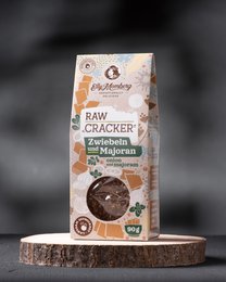 Flax crackers with onion and marjoram, made from raw ingredients. Rectangular package with product name and ingredients visible.