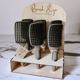A set of 20+ black and white hairbrushes with a grid-like pattern, designed for quick and easy hair brushing on the go.