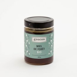 Organic forest honey in a glass jar. The honey has a rich, natural flavor and is packaged in a simple, minimalist design.