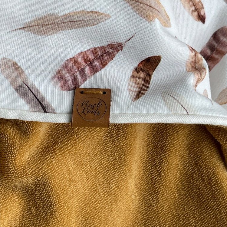 Tissu éponge enveloppant de plumes