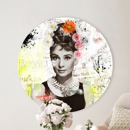 Circular wall art featuring a portrait of Audrey Hepburn with colorful floral accents. The product is available in three sizes: 40 cm, 60 cm, and 80 cm in diameter.