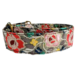 Colorful floral embroidered shoulder bag with adjustable strap.