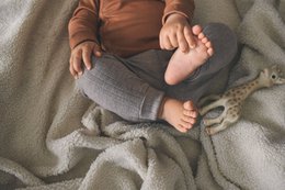 Soft, cozy gray baby leggings with a ribbed texture and comfortable waistband.