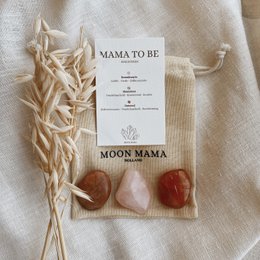 Gemstones set for expecting mothers, including crystals in various shapes and colors.