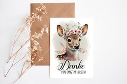 Thanksgiving postcard with a deer illustration and the text "Danke" (German for "Thank you"). The postcard has a kraft paper background with floral accents.