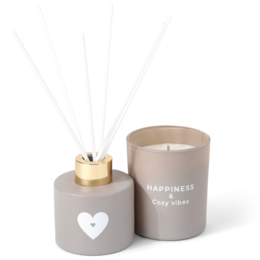 Tall, round white candle and diffuser set in a white gift box with "Happiness" printed on it. Includes a ceramic diffuser vessel.