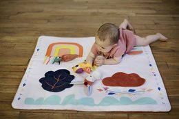 Colorful playmat with rabbit design, suitable for children's play area. Soft, durable material in rectangular shape.