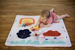 Colorful playmat with rabbit design, suitable for children's play area. Soft, durable material in rectangular shape.